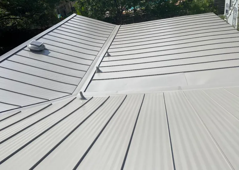 Solar attic fan installed on a metal roof for Roof Ventilation in Ithaca
